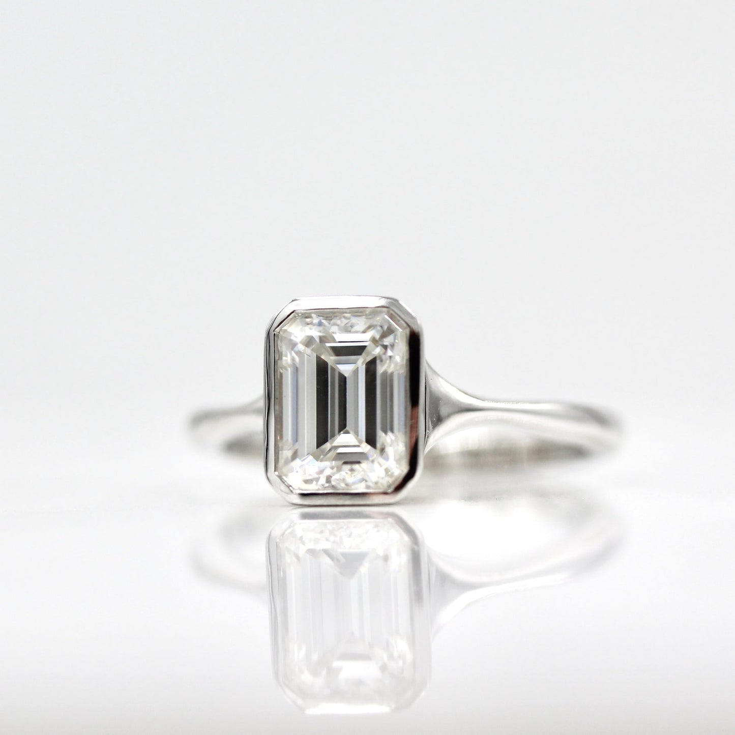 Solitaire Colorless Bezel Emerald Cut Moissanite Engagement Ring